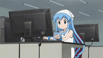 Woman types at a computer.